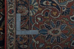 Backside of handmade 1930s Kashan rug showing knot structure and weave density