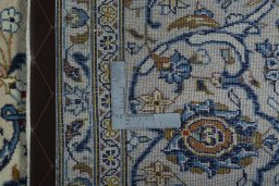 Backside of handmade 2000s Kashan rug showing knot structure and weave density