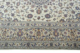 Corner detail of 2000s Kashan rug showing border pattern and Wool pile