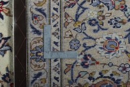 Backside of handmade 2000s Kashan rug showing knot structure and weave density