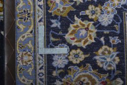 Backside of handmade 2000s Kashan rug showing knot structure and weave density
