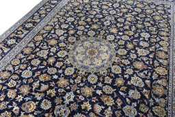 Backside of handmade 2000s Kashan rug showing knot structure and weave density