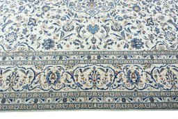 Corner detail of 2000s Kashan rug showing border pattern and Wool pile