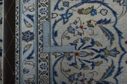 Backside of handmade 2000s Kashan rug showing knot structure and weave density