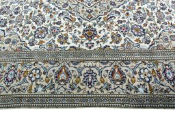 Corner detail of 2000s Kashan rug showing border pattern and Wool pile