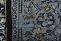 Backside of handmade 2000s Kashan rug showing knot structure and weave density