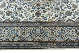 Corner detail of 2000s Kashan rug showing border pattern and Wool pile