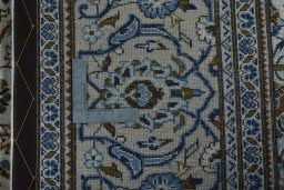 Backside of handmade 2000s Kashan rug showing knot structure and weave density
