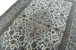 Backside of handmade 2000s Kashan rug showing knot structure and weave density