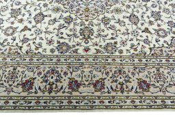Corner detail of 2000s Kashan rug showing border pattern and Wool pile