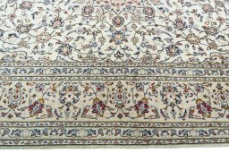 Corner detail of 2000s Kashan rug showing border pattern and Wool pile