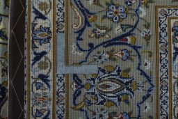Backside of handmade 2000s Kashan rug showing knot structure and weave density
