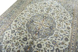 Backside of handmade 2000s Kashan rug showing knot structure and weave density