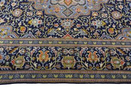 Corner detail of 2000s Kashan rug showing border pattern and Wool pile