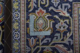Backside of handmade 2000s Kashan rug showing knot structure and weave density