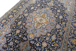 Backside of handmade 2000s Kashan rug showing knot structure and weave density