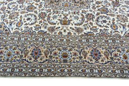 Corner detail of 2000s Kashan rug showing border pattern and Wool pile