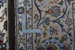 Backside of handmade 2000s Kashan rug showing knot structure and weave density