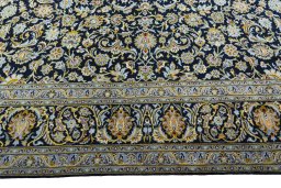 Corner detail of 2000s Kashan rug showing border pattern and Wool pile