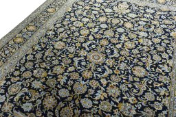 Backside of handmade 2000s Kashan rug showing knot structure and weave density