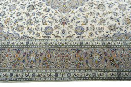 Corner detail of 2000s Kashan rug showing border pattern and Wool pile