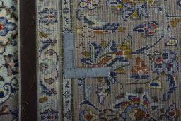 Backside of handmade 2000s Kashan rug showing knot structure and weave density