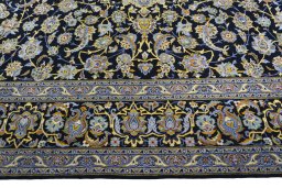 Corner detail of 2000s Kashan rug showing border pattern and Wool pile
