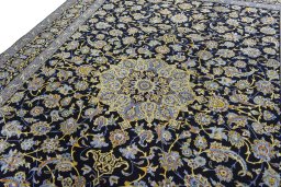 Backside of handmade 2000s Kashan rug showing knot structure and weave density