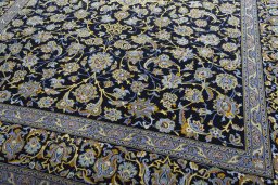 Close-up detail of 2000s Kashan rug from Iran / Persia showing Wool weave