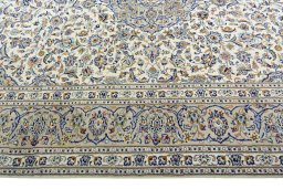 Corner detail of 2000s Kashan rug showing border pattern and Wool pile