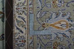 Backside of handmade 1970s Kashan rug showing knot structure and weave density