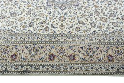 Corner detail of 2000s Kashan rug showing border pattern and Wool pile