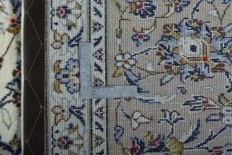 Backside of handmade 2000s Kashan rug showing knot structure and weave density