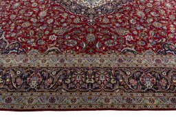 Corner detail of New Kashan rug showing border pattern and Wool pile