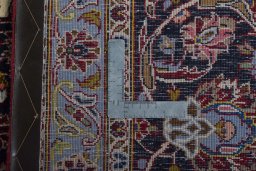 Backside of handmade New Kashan rug showing knot structure and weave density