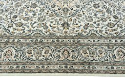 Corner detail of 2000s Kashan rug showing border pattern and Wool pile
