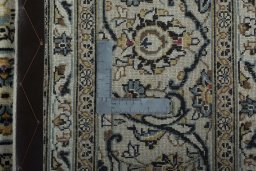 Backside of handmade 2000s Kashan rug showing knot structure and weave density
