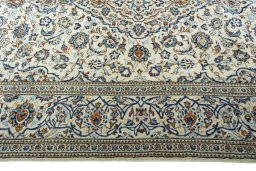 Corner detail of 2000s Kashan rug showing border pattern and Wool pile