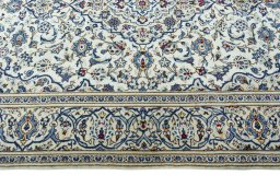 Corner detail of 2000s Kashan rug showing border pattern and Wool pile