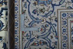 Backside of handmade 2000s Kashan rug showing knot structure and weave density