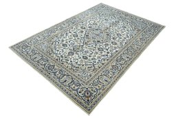 Corner detail of 2000s Kashan rug showing border pattern and Wool pile