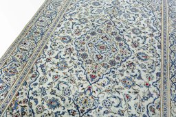 Backside of handmade 2000s Kashan rug showing knot structure and weave density