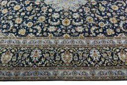 Corner detail of 2000s Kashan rug showing border pattern and Wool pile
