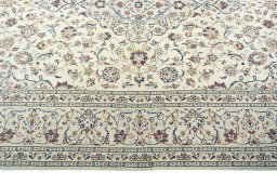Corner detail of 2000s Kashan rug showing border pattern and Wool pile