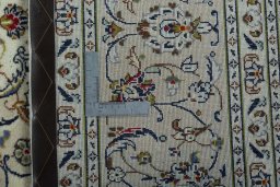 Backside of handmade 2000s Kashan rug showing knot structure and weave density