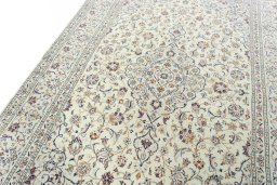 Backside of handmade 2000s Kashan rug showing knot structure and weave density