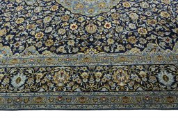 Corner detail of 2000s Kashan rug showing border pattern and Wool pile
