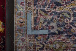Backside of handmade 2000s Kashan rug showing knot structure and weave density