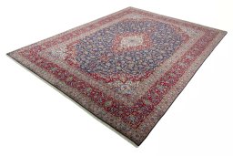 Corner detail of 2000s Kashan rug showing border pattern and Cork pile