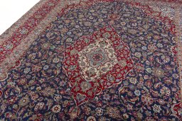 Backside of handmade 2000s Kashan rug showing knot structure and weave density